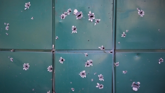 Shrapnel traces on a house damaged by Russian night shelling in Ukraine