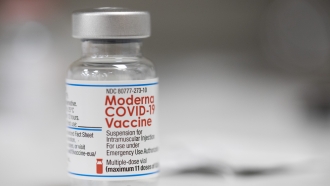 A vial of the Moderna COVID-19 vaccine is displayed on a counter at a pharmacy