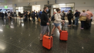 Travelers are shown at Salt Lake City International Airport.