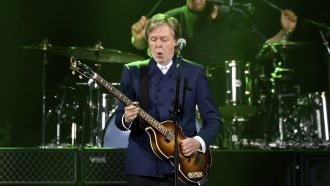 Paul McCartney performs on stage.