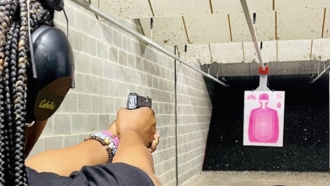 Woman in a Chicks With Triggers shooting range.