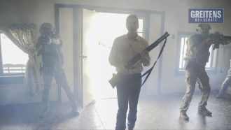 Republican U.S. Senate candidate Eric Greitens holds a shotgun in a campaign ad.
