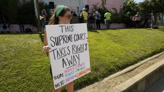 An abortion rights supporter holds her protest sign outside the Jackson Women's Health Organization clinic in Jackson, Miss.