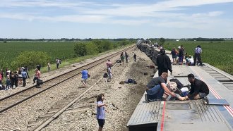 Amtrak passenger train lies on its side after derailing