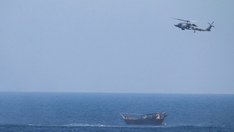 U.S. Navy helicopter over a vessel