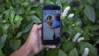 Mynor Cardona shows a photo on his cellphone of her daughter, Yenifer Yulisa Cardona Tomás