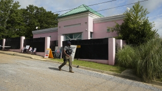 A security officer walks past the front of the Jackson Women's Health Organization clinic in Jackson, Mississippi