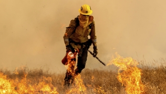 Firefighter works near a wildfire