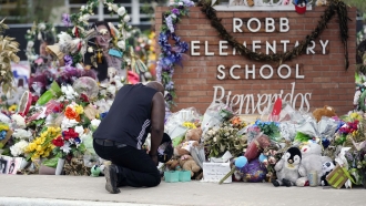A man pays his respects a memorial at Robb Elementary School in Uvalde, Texas
