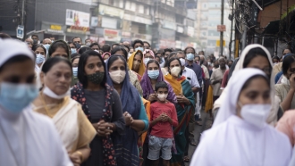 Indian Christians wearing face masks during prayer