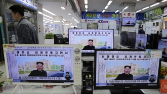 TV monitors display a North Korean newspaper