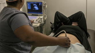 An operating room technician performs an ultrasound on a patient at an abortion clinic.