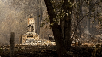 A chimney stands at a home destroyed by the McKinney Fire on Tuesday, Aug. 2, 2022