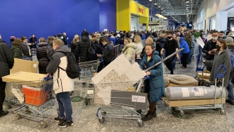 People wait to check out at IKEA.