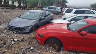 Cars are stuck in mud and debris from flash flooding at The Inn at Death Valley in Death Valley National Park, California.