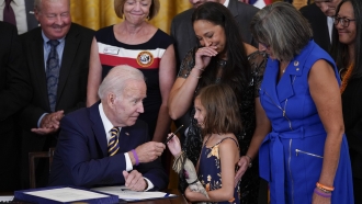 President Biden gives pen he used to sign the "PACT Act of 2022" to Brielle Robinson, daughter of Sgt. Heath Robinson.