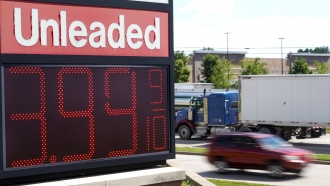 The price of regular unleaded gas is advertised for just under $4 a gallon
