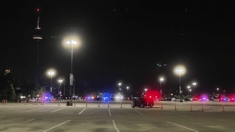 Emergency vehicles are shown in the parking lot of Six Flags Great America in Gurnee, Ill.