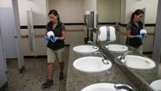 A woman organizes a public bathroom.