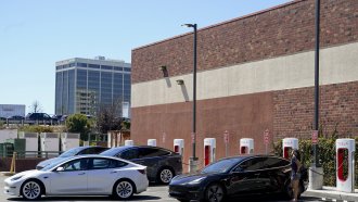 Motorists charge their vehicles at a Tesla charging station in Emeryville