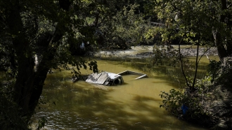 A truck is sunk in water after massive flooding in Hindman