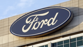 Ford logo is seen on the automaker's headquarters in Dearborn, Mich.