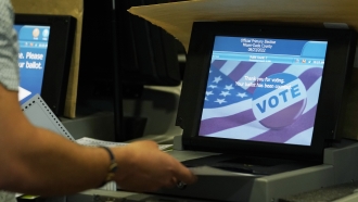 Election employee tests voting equipment