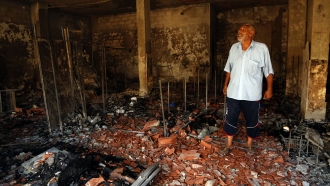 A man surveys the damage from clashes in the Libyan capital of Tripoli.