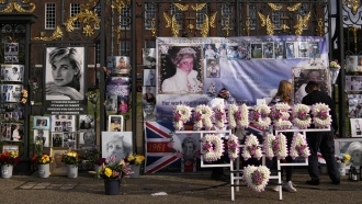 A floral arrangement and messages of remembrance for Princess Diana