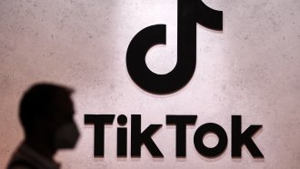 A visitor passes the TikTok exhibition stands at the Gamescom computer gaming fair in Cologne