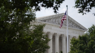 An American flag waves in front of the U.S. Supreme Court building