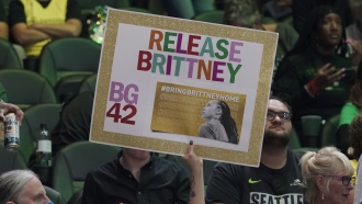 A fan at a WNBA basketball game holds up a sign supporting Phoenix Mercury player Brittney Griner