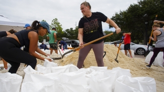 Felicia Livengood, 29, and Victoria Colson, 31, fill sandbags along with hundreds of other Tampa.