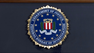 FBI seal on a podium before a news conference at the agency's headquarters in Washington