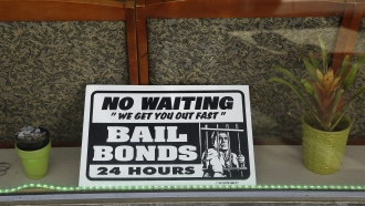 a sign is seen in the window of a bail bonds office across from the Hall of Justice in San Francisco