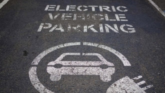sign of electric car charging space is seen at a beachside car park in Sydney, Australia