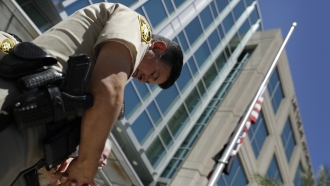 A Las Vegas Metropolitan Police officer bows his head.