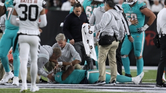 Miami Dolphins quarterback Tua Tagovailoa is examined on the field after a hit during a game against the Cincinnati Bengals.