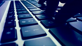 A person types on a keyboard.