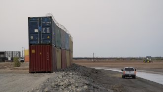 Shipping containers stacked near the U.S.-Mexico border.