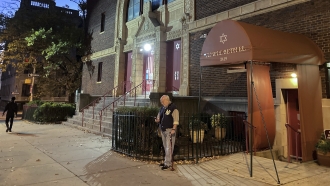 Man stands outside a synagogue.