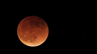 The moon is shown during a full lunar eclipse