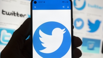 The Twitter logo is shown on a phone.