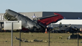 Debris from two planes that crashed during an airshow at Dallas Executive Airport lie on the ground.