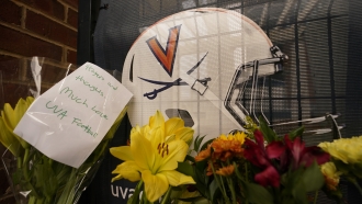 Memorial flowers and notes at Scott Stadium.