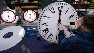 A man assembles clocks