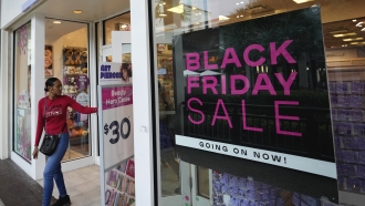 Shoppers exit a Claire's accessories store advertising sales ahead of Black Friday.