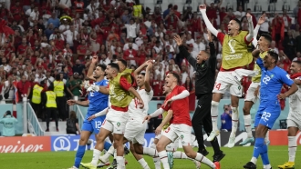 Morocco players celebrate after the World Cup group F soccer match between Belgium.