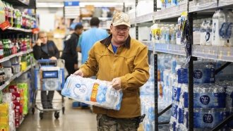 A man buys cases of water after learning that a boil water notice was issued for the entire city of Houston, Texas
