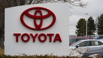 Toyota logo adorns a sign outside a Toyota dealership